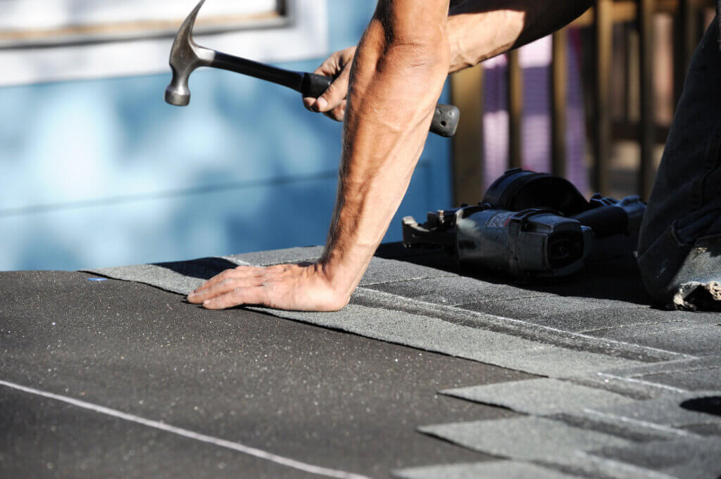 handyman making roofing repairs