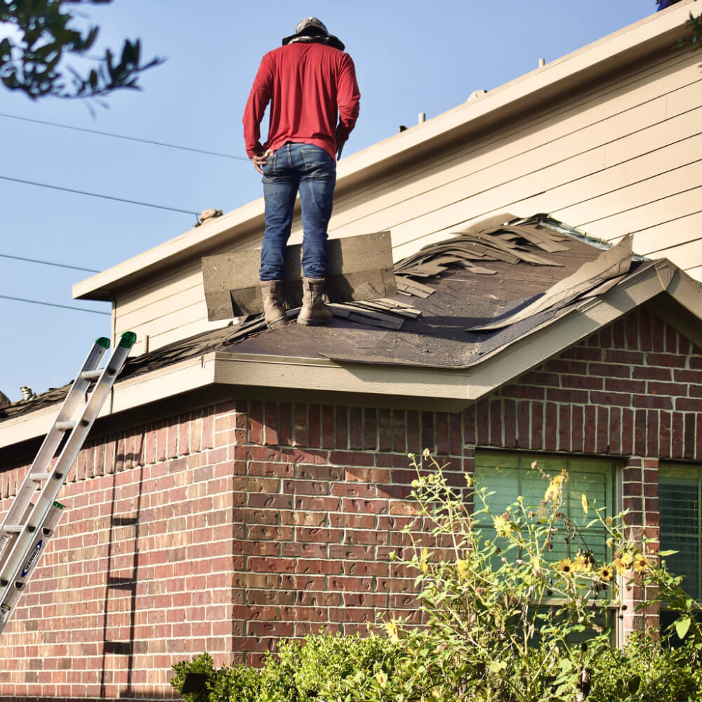 A McCoy Roofing worker working on a roof, providing roof replacement.