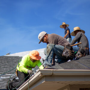 McCoy Roofing workers changing shingles on a roof.