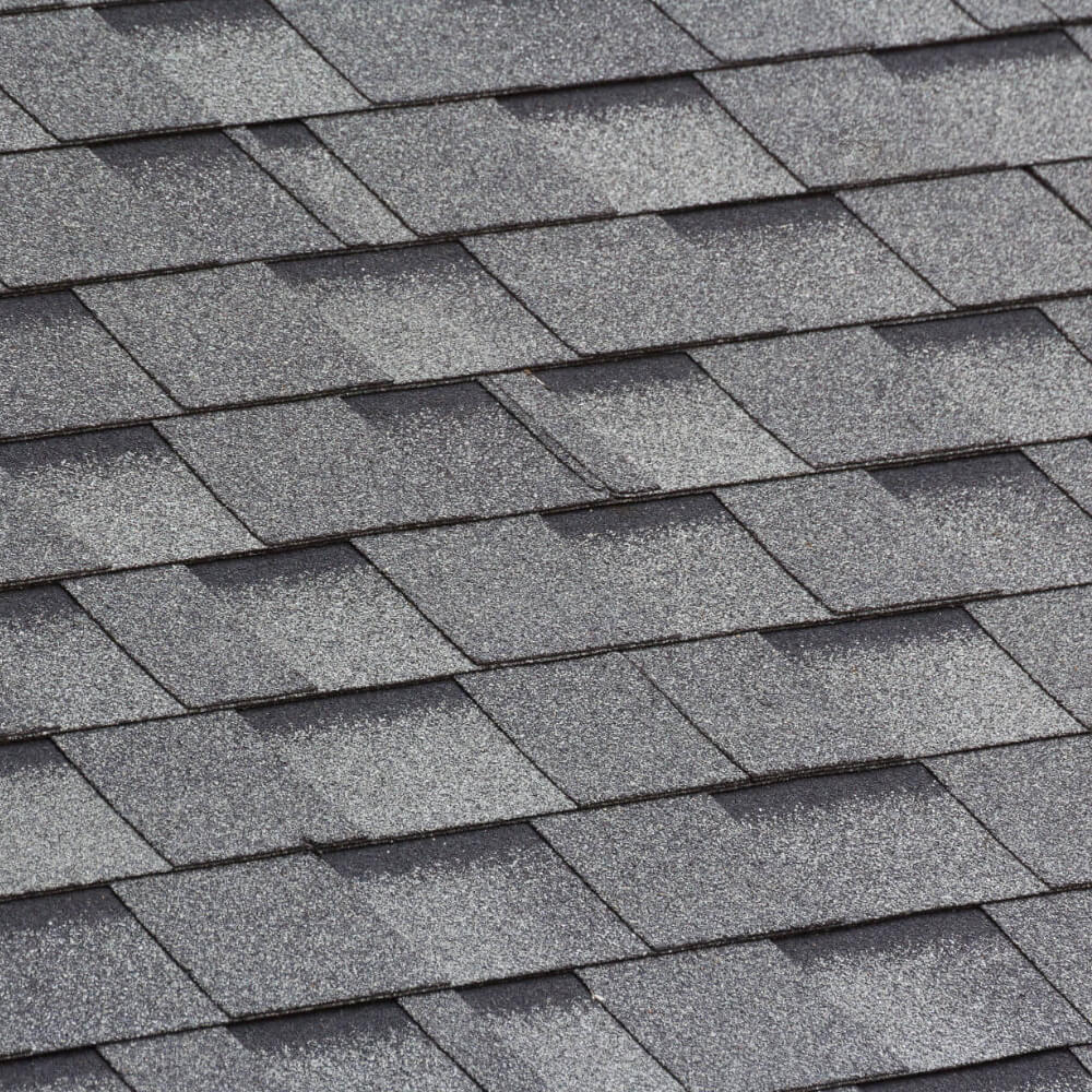 Photo of a roofs shingles after having them replaced and cleaned.