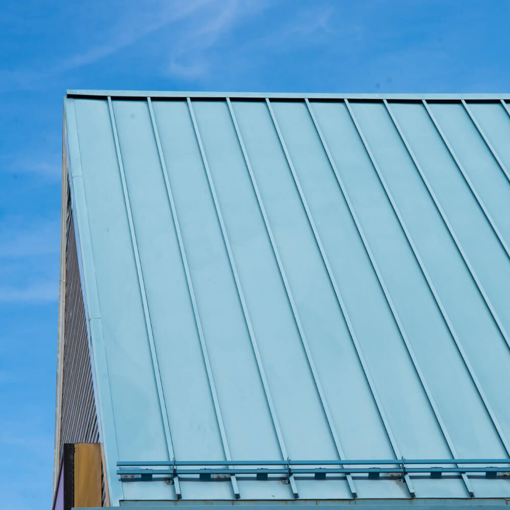 Picture of a house's blue metal roof. 