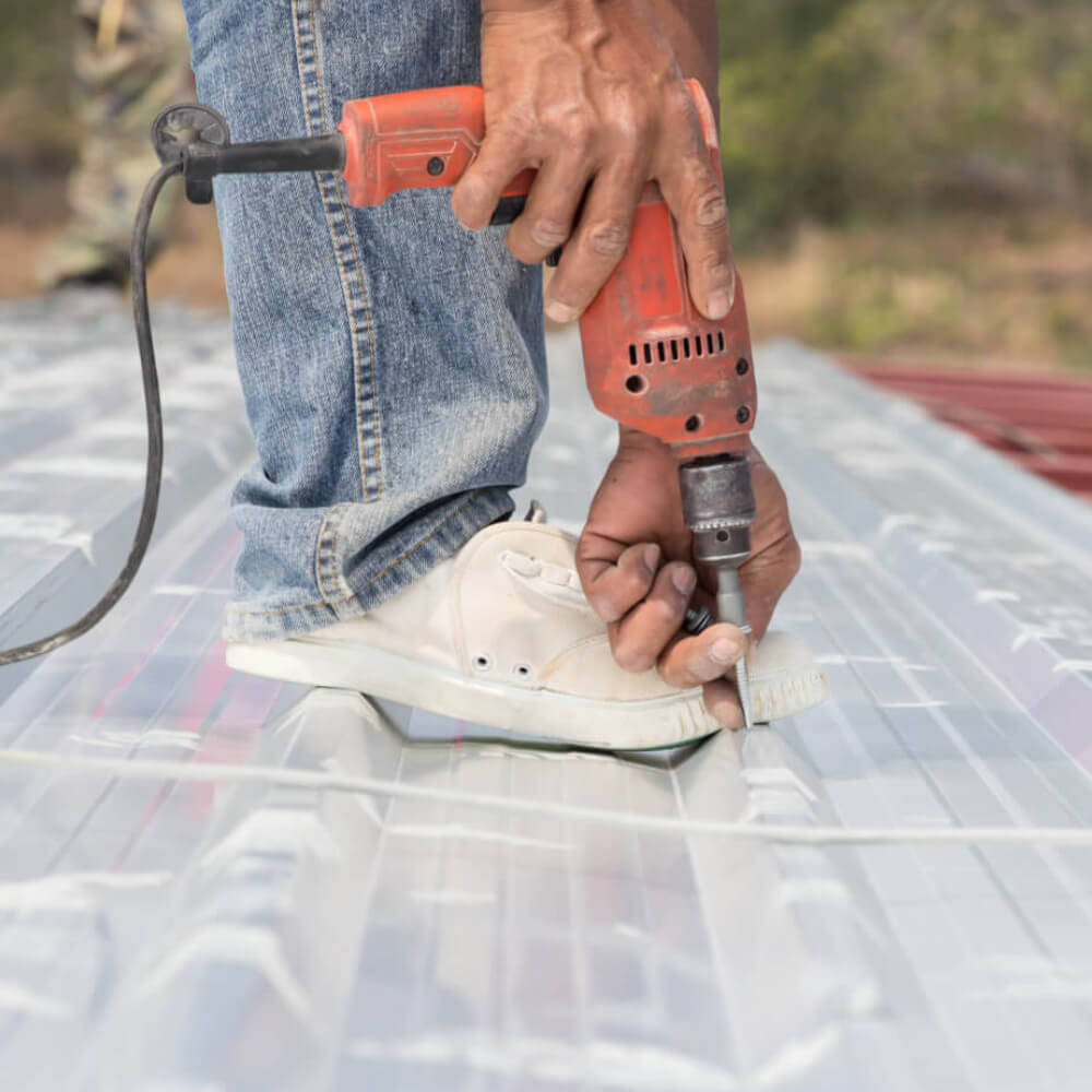 McCoy Roofing worker working on a metal roof.