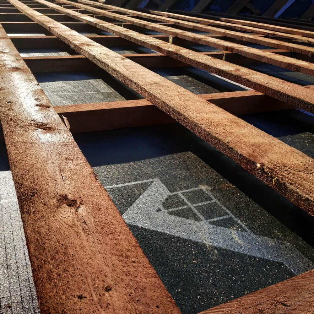 Picture displaying a roof underlayment, important step before doing a roof replacement.