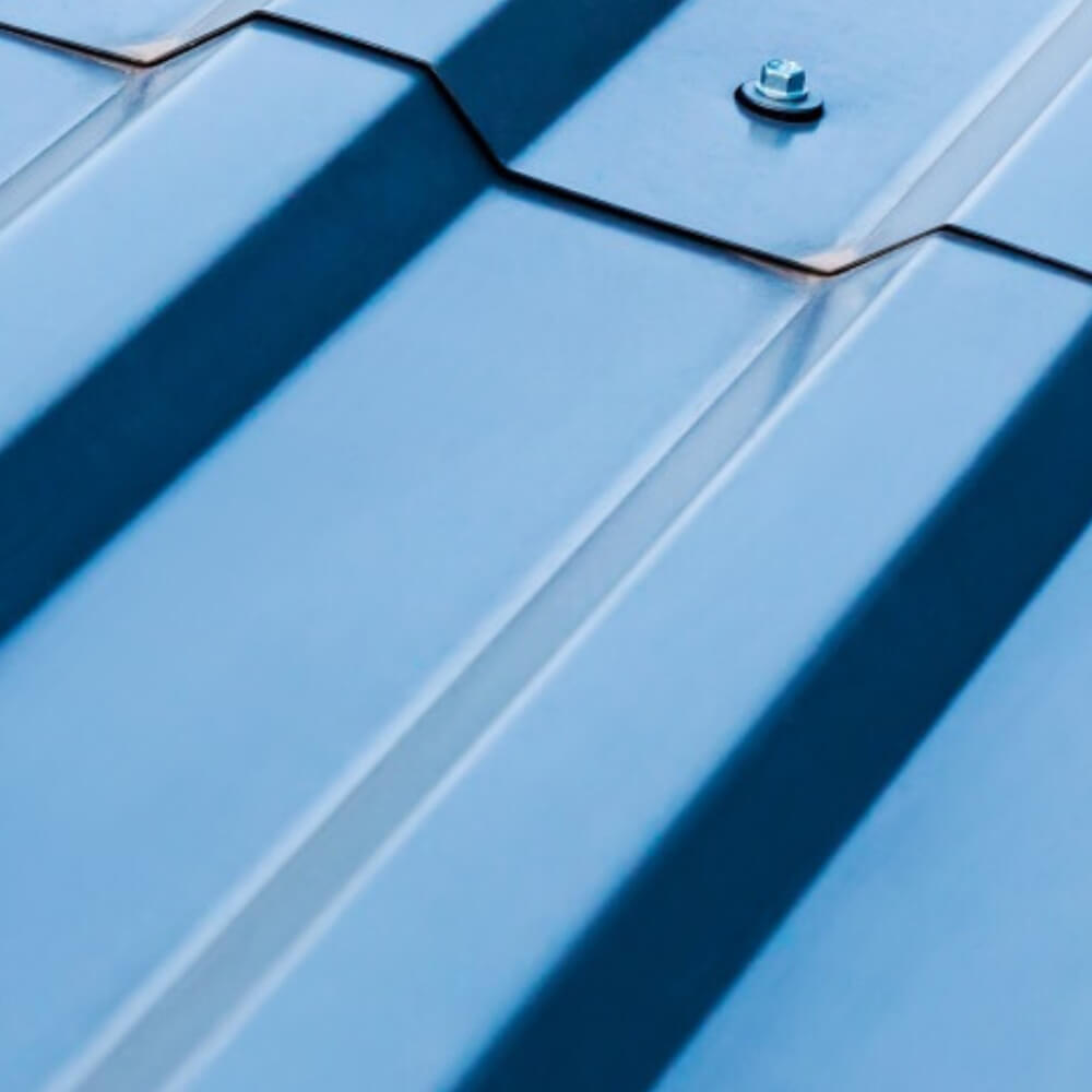 Closeup picture of metal roof installed over plywood.
