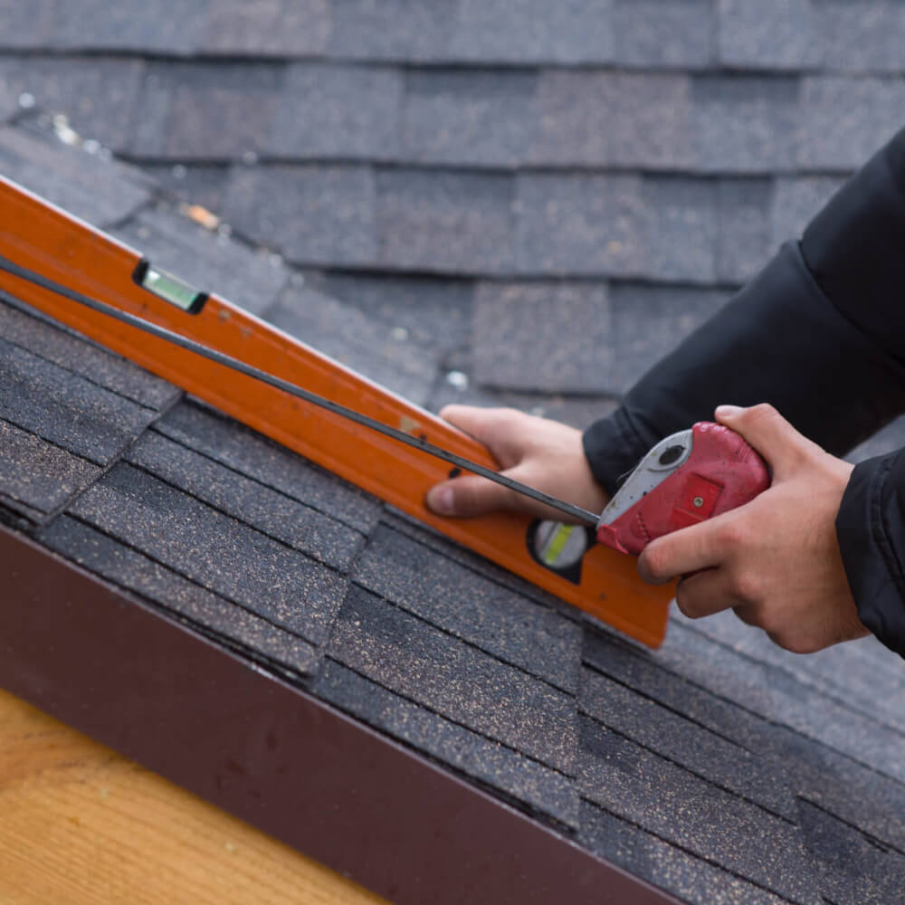 A McCoy Roofing worker installing shingles on a customers roof. 