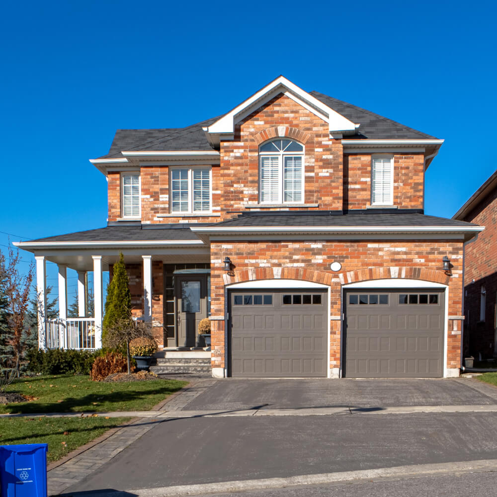 Frontview of a house using charcoal colored roof shingles after choosing the best color for their brick house.