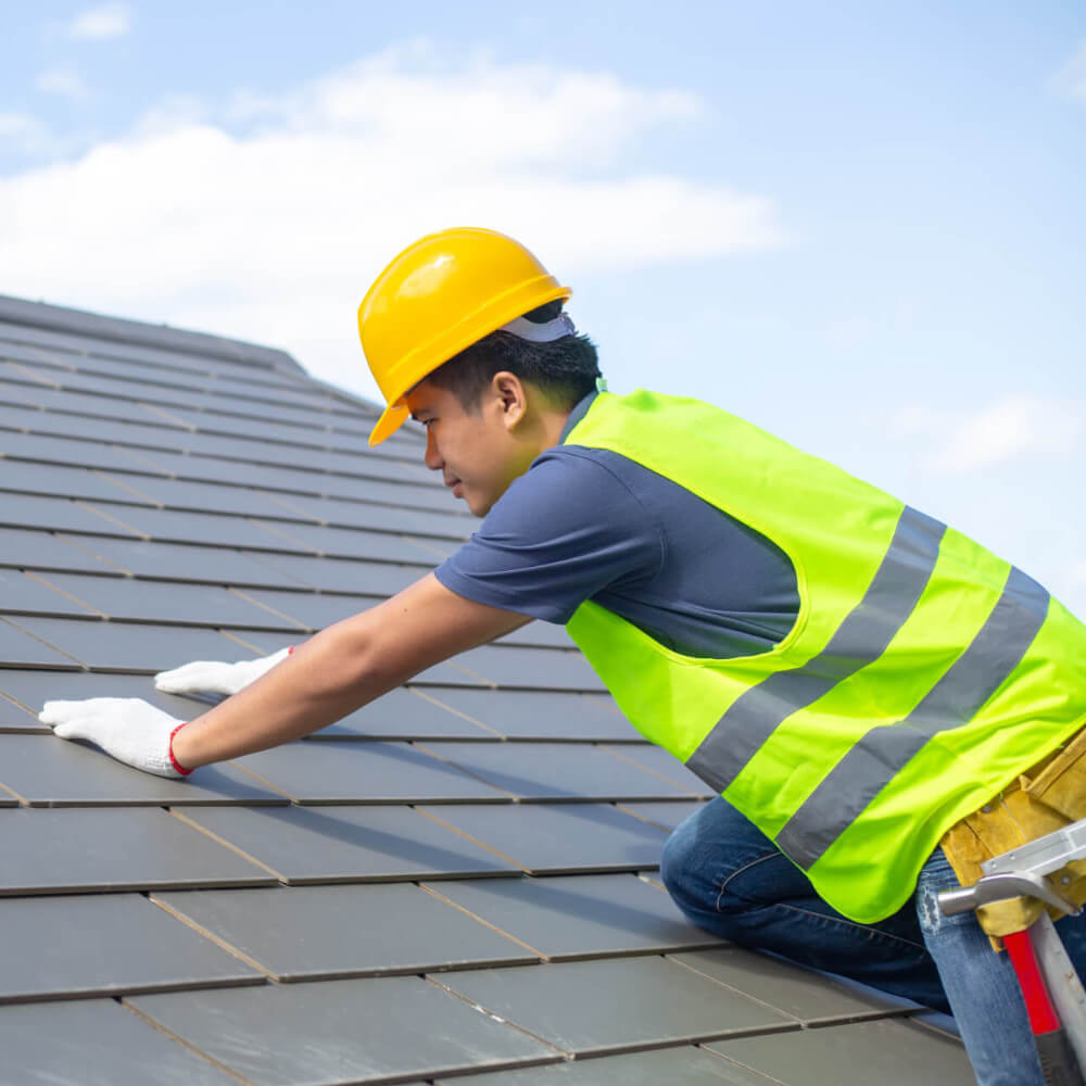 McCoy Roofing's worker inspected and giving maintenance care to a roof to extend the roof's life.