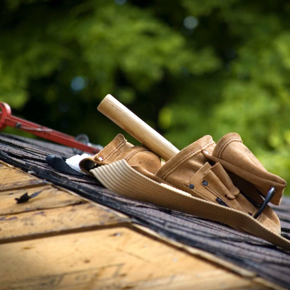 Workers tools on a roof, picture taken before working on a roof replacement done by McCoy Roofing.