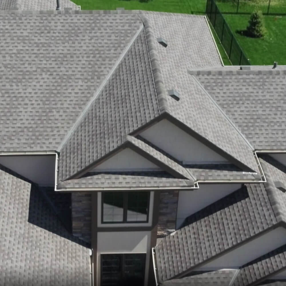 Birdseye photo a house's roof after having a roof replacement.