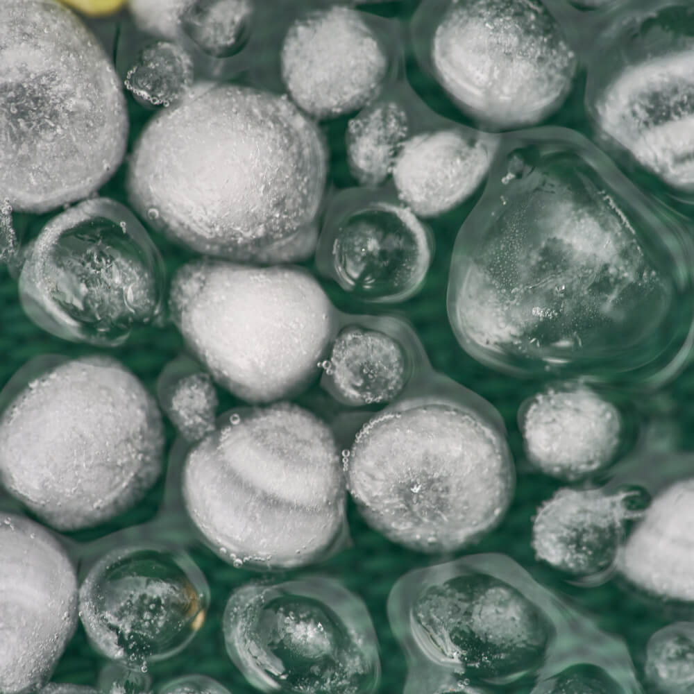 Picture displaying hail from a storm and how it can harm your roofs health.