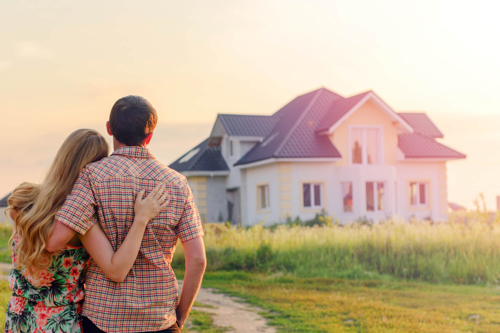 Beauty shot of a couple appreciating their home with McCooy Roofin’s roof