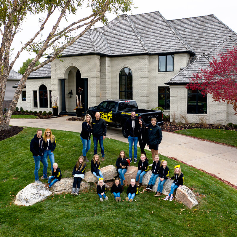 McCy Roofing team in front of a new roof. 