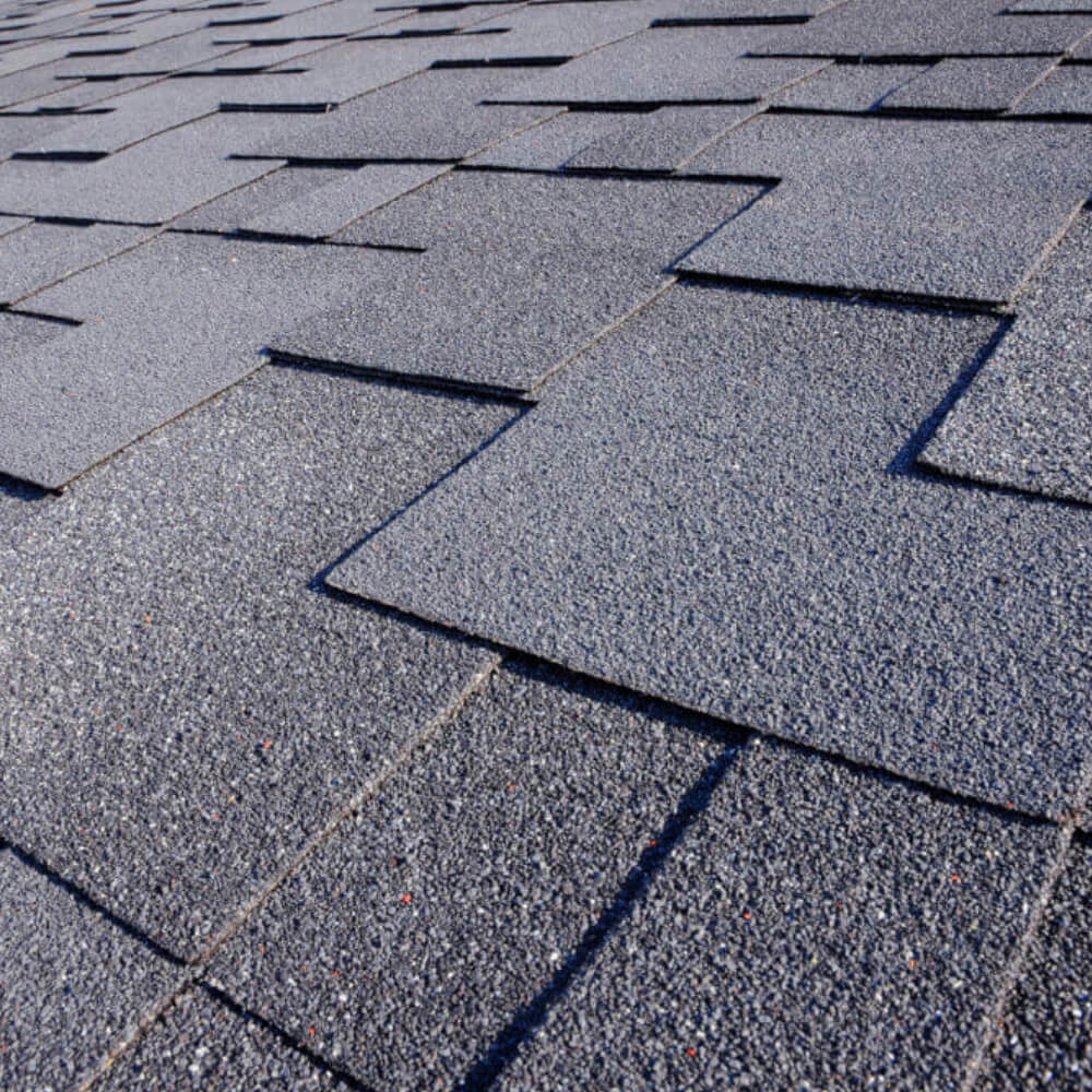 Close up shot of shingles on a home with McCoy Roofing's roof.